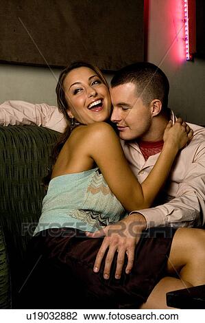 Stock Image - A young couple embracing. Fotosearch