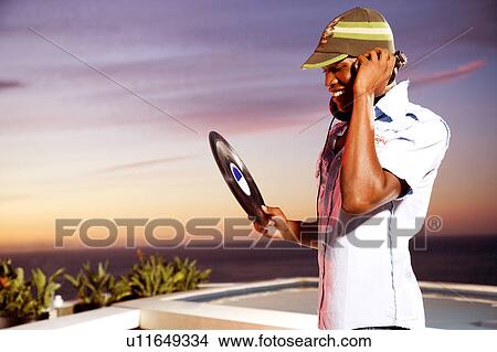 Picture - DJ selecting next record. Fotosearch