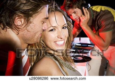 Young couple at a party View Large Photo Image Stock Photograph - Young couple at a party. Fotosearch