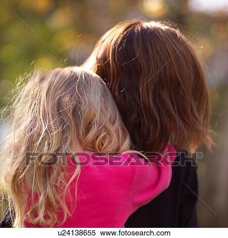 Back view of a young child hugging her mother View Large Photo Image Stock Photography - Back view of a young child hugging her mother. Fotosearch