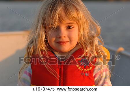 Blond girl wearing a lifejacket View Large Photo Image Stock Photography - Blond girl wearing a lifejacket. Fotosearch
