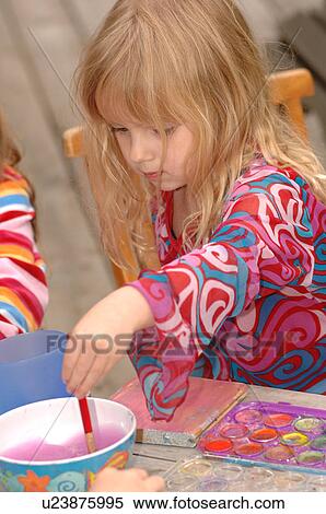 Stock Photography - Blonde child painting. Fotosearch