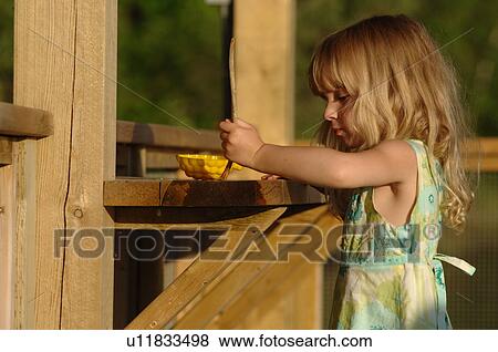 Child standing outside drawing View Large Photo Image Stock Photo - Child standing outside drawing. Fotosearch