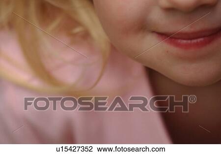 Stock Image - Close-up of the mouth of a young girl smiling. Fotosearch