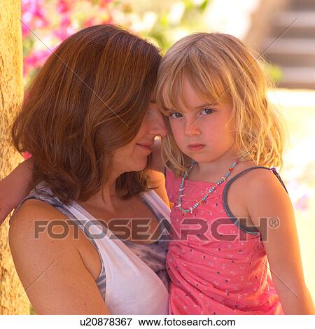 Mother cuddling with her daugher View Large Photo Image Stock Photo - Mother cuddling with her daugher. Fotosearch