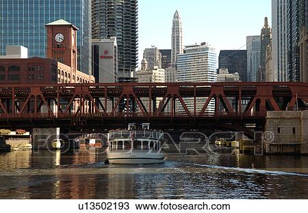 Boat passing under a bridge View Large Photo Image Stock Image - Boat passing under a bridge. Fotosearch