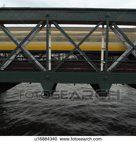 Train moving on a bridge in London, England View Large Photo Image Stock Image - Train moving on a bridge in London, England. Fotosearch