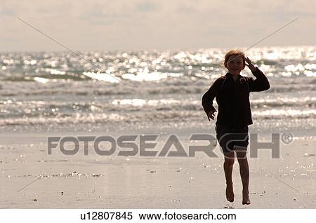 Silhouette of child with ocean in background View Large Photo Image Stock Photography - Silhouette of child with ocean in background. Fotosearch