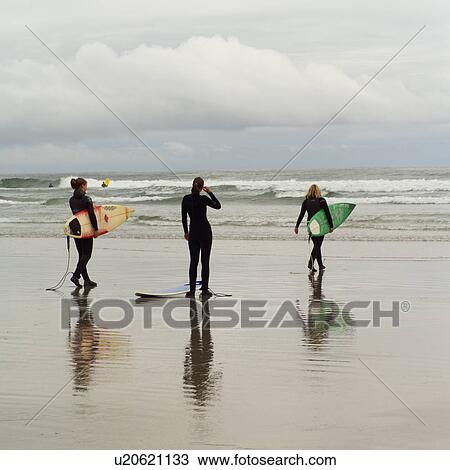 Surfers with surfboards on beach View Large Photo Image Stock Image - Surfers with surfboards on beach. Fotosearch