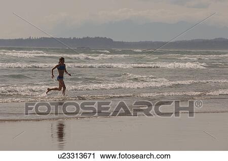 Woman running out of ocean View Large Photo Image Stock Image - Woman running out of ocean. Fotosearch
