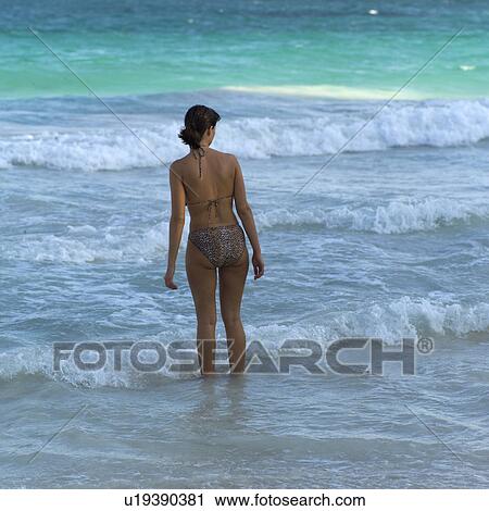 Stock Image - Woman Standing at Shore. Fotosearch