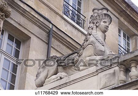 Low angle view of a stone sculpture outside a building in Paris, France View Large Photo Image Stock Photo - Low angle view of a stone sculpture outside a building in Paris, France. Fotosearch