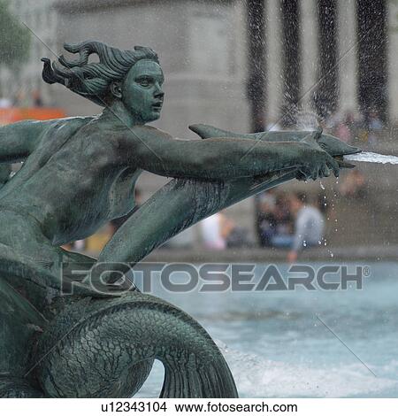 Statue at a fountain in Trafalgar square, London, England View Large Photo Image Picture - Statue at a fountain in Trafalgar square, London, England. Fotosearch