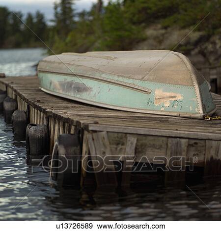 Boat turned over on a pier View Large Photo Image Stock Photo - Boat turned over on a pier. Fotosearch