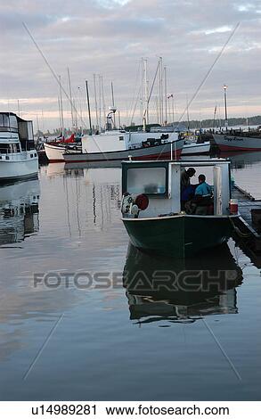 Stock Image - Boats docked at a harbor. Fotosearch