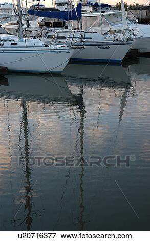 Boats docked at a harbor View Large Photo Image Stock Photo - Boats docked at a harbor. Fotosearch