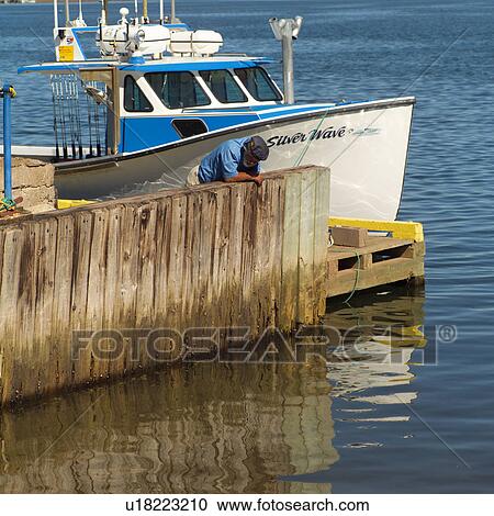 Fishing boat docked at a harbor View Large Photo Image Stock Image - Fishing boat docked at a harbor. Fotosearch
