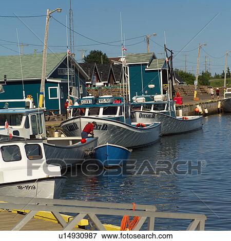 Fishing boats docked at a harbor View Large Photo Image Stock Photo - Fishing boats docked at a harbor. Fotosearch
