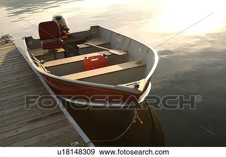 Stock Photo - Motor boat tied to a pier. Fotosearch