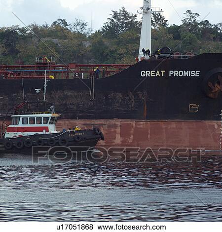 Stock Photo - Tug boat along a ship, Havana, Cuba. Fotosearch