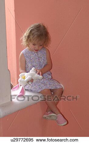 Stock Photography - Child playing with bunny. Fotosearch