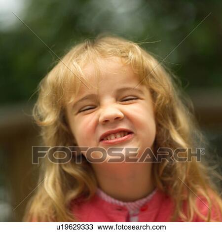 Stock Image - Close-up of a girl making a face at the camera. Fotosearch