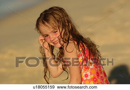 Close-up of a young girl (6-8) on a beach View Large Photo Image Stock Photo - Close-up of a young girl (6-8) on a beach. Fotosearch