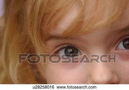 Close-up of a young girl looking at camera View Large Photo Image Stock Photograph - Close-up of a young girl looking at camera. Fotosearch
