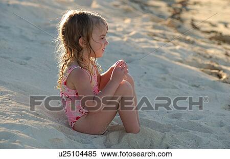 Close-up of a young girl on a beach View Large Photo Image Stock Photography - Close-up of a young girl on a beach. Fotosearch