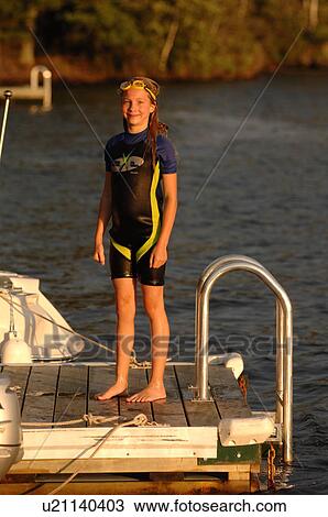 Girl standing on dock at Lake of the Woods View Large Photo Image Stock Image - Girl standing on dock at Lake of the Woods. Fotosearch