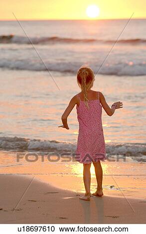 Stock Image - Kids playing on beach - Hawaii. Fotosearch