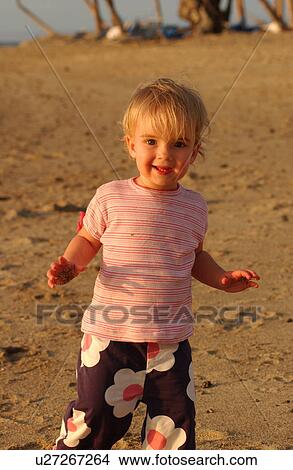 Picture - Kids playing on beach. Fotosearch