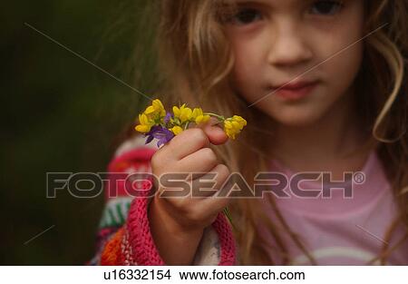 Young girl holding a bunch of flowers View Large Photo Image Picture - Young girl holding a bunch of flowers. Fotosearch