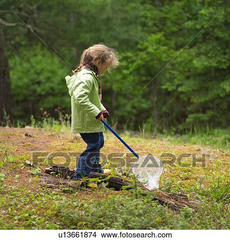 Young girl holding a butterfly net in the woods View Large Photo Image Picture - Young girl holding a butterfly net in the woods. Fotosearch