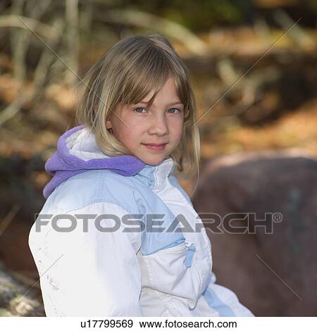 Stock Photo - Young girl looking at camera smiling. Fotosearch