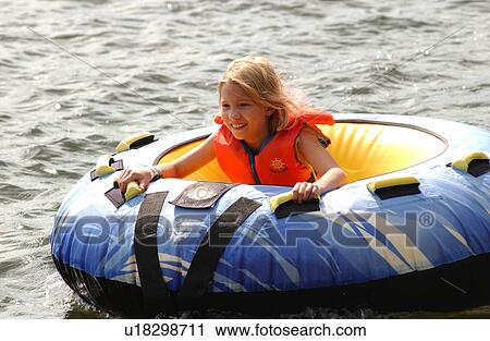 Stock Image - Young girl sitting in a raft. Fotosearch
