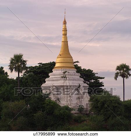 Golden tower of Temple along shoreline View Large Photo Image Stock Photo - Golden tower of Temple along shoreline. Fotosearch