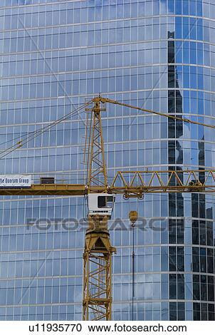 Stock Image - Crane next to a highrise in downtown Vancouver. Fotosearch