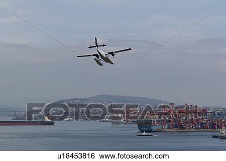 Stock Photograph - Plane decending into Vancouver Harbour. Fotosearch