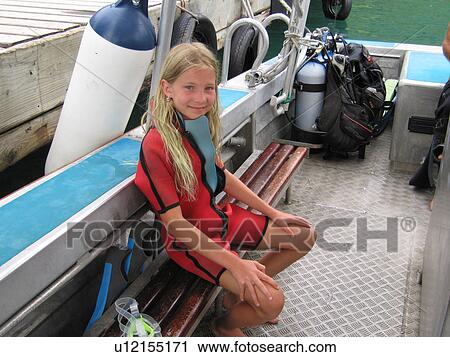 A young girl sitting in a boat with scuba gear, Moorea, Tahiti, French Polynesia, South Pacific View Large Photo Image Stock Image - A young girl sitting in a boat with scuba gear, Moorea, Tahiti, French Polynesia, South Pacific. Fotosearch