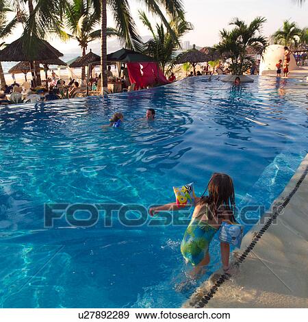 Back view of a child entering a swimming pool View Large Photo Image Stock Photo - Back view of a child entering a swimming pool. Fotosearch