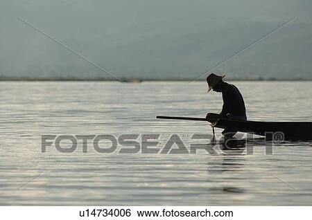 Fisherman in row boat View Large Photo Image Stock Photograph - Fisherman in row boat. Fotosearch