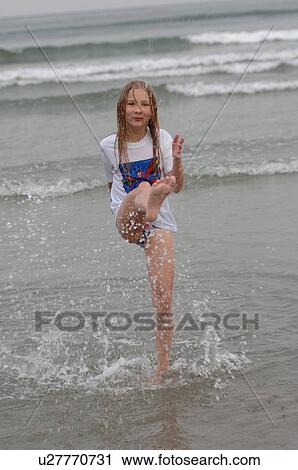 Girl kicking her leg in water, Wickaninnish Beach, Vancouver Island, Canada View Large Photo Image Stock Image - Girl kicking her leg in water, Wickaninnish Beach, Vancouver Island, Canada. Fotosearch
