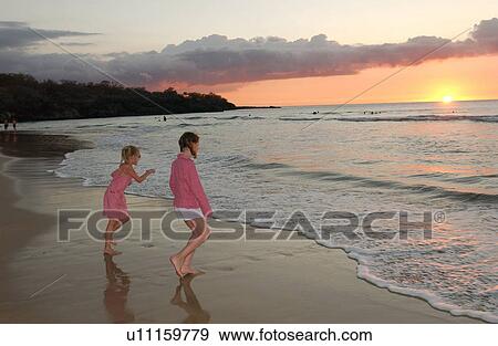 Kids playing on beach - Hawaii View Large Photo Image Stock Photo - Kids playing on beach - Hawaii. Fotosearch