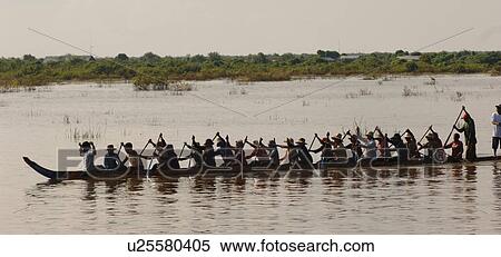 Silhouette of group paddling a canoe in Cambodia View Large Photo Image Stock Photography - Silhouette of group paddling a canoe in Cambodia. Fotosearch