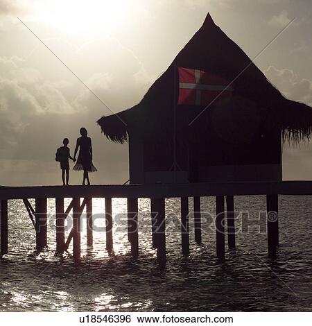 Stock Photograph - Silhouette of Mother and Daughter at Moorea in Tahiti. Fotosearch