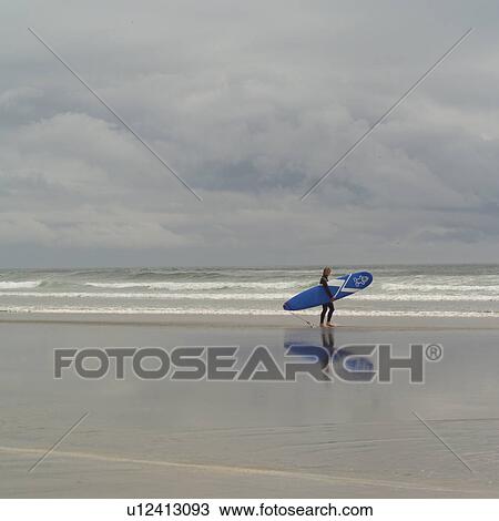 Surfer with surfboard on beach, Pacific Rim Park, Vancouver Island, Canada View Large Photo Image Stock Image - Surfer with surfboard on beach, Pacific Rim Park, Vancouver Island, Canada. Fotosearch