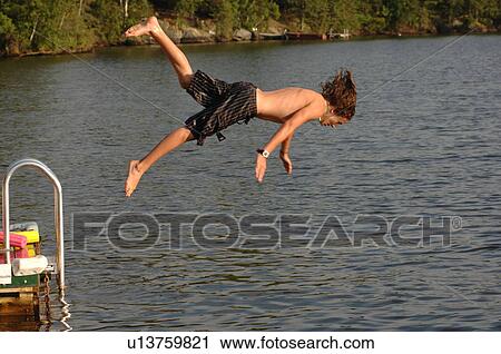 Teenage boy diving into the lake View Large Photo Image Stock Image - Teenage boy diving into the lake. Fotosearch