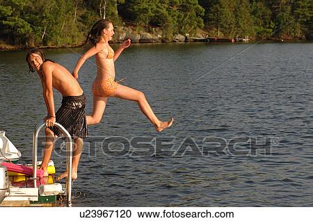 Teenage girl jumping into the lake View Large Photo Image Stock Image - Teenage girl jumping into the lake. Fotosearch