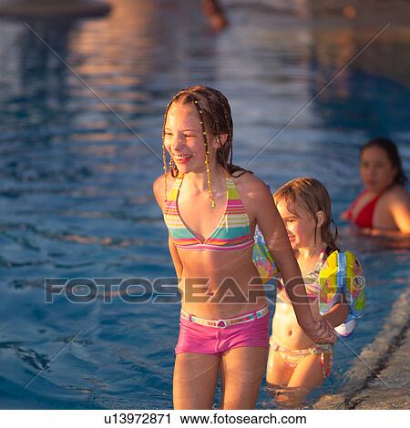 Stock Image - Two girls in swimming pool. Fotosearch